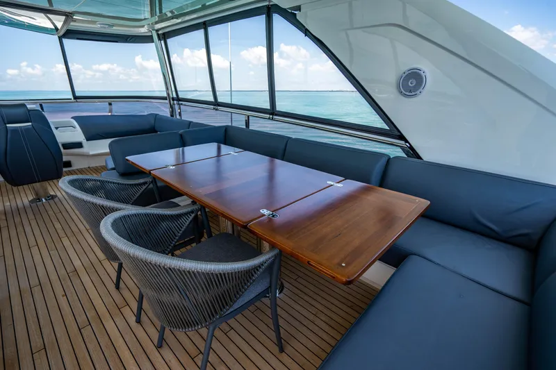 Slide: The Image of 2018 Princess Y75 Motor Yacht interior with wooden table and ocean view. - 40