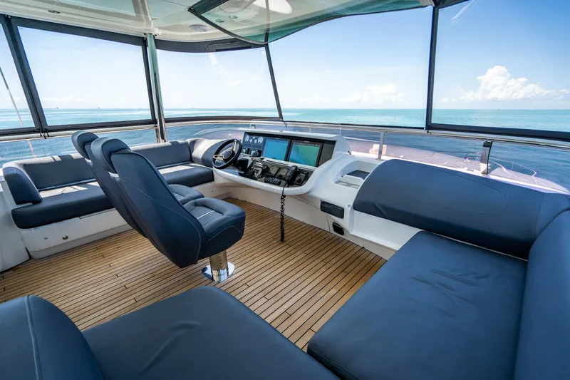 Slide: The Image of 2018 Princess Y75 Motor Yacht helm station with ocean view and luxurious seating. - 42