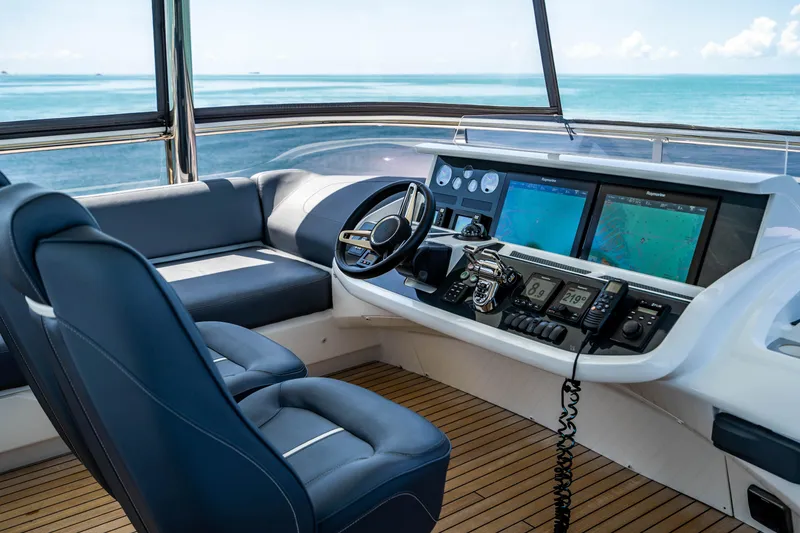 Slide: The Image of 2018 Princess Y75 Motor Yacht helm station with ocean view and advanced navigation systems. - 43