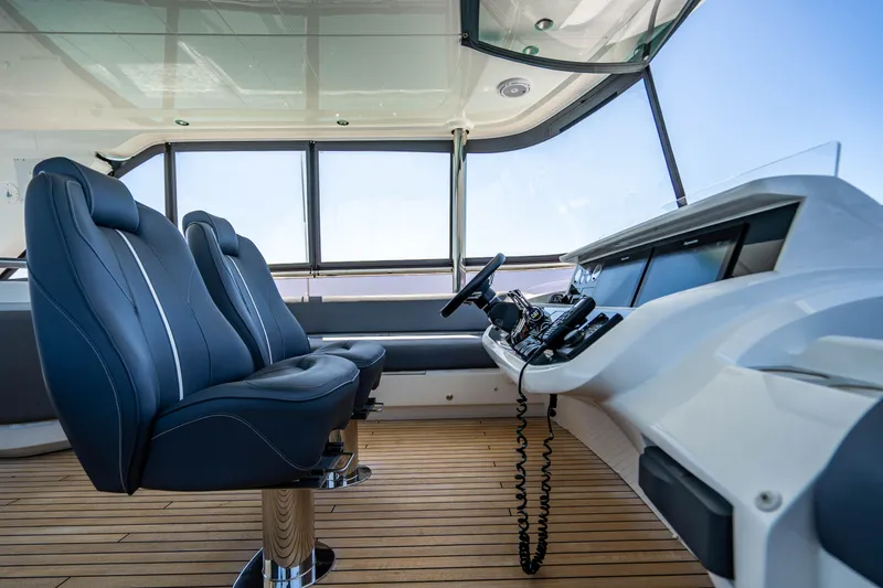 Slide: The Image of Interior helm of 2018 Princess Y75 Motor Yacht with leather seats and modern controls. - 44