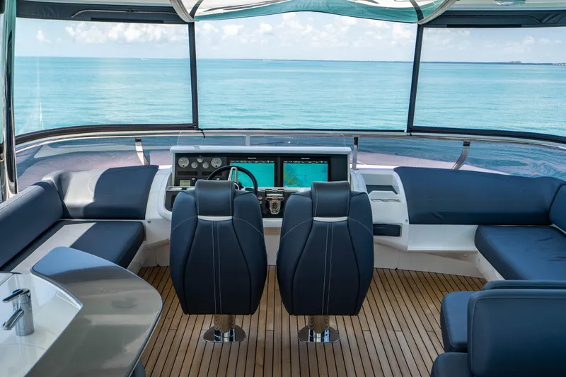 Slide: The Image of 2018 Princess Y75 Motor Yacht helm station with ocean view and luxurious seating. - 45
