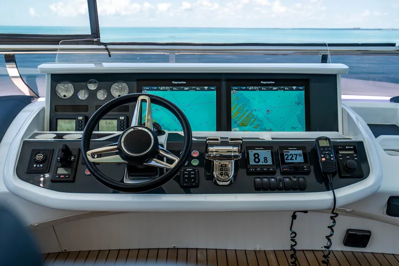 Slide: The Image of Helm station of 2018 Princess Y75 Motor Yacht with navigation screens and controls. - 46