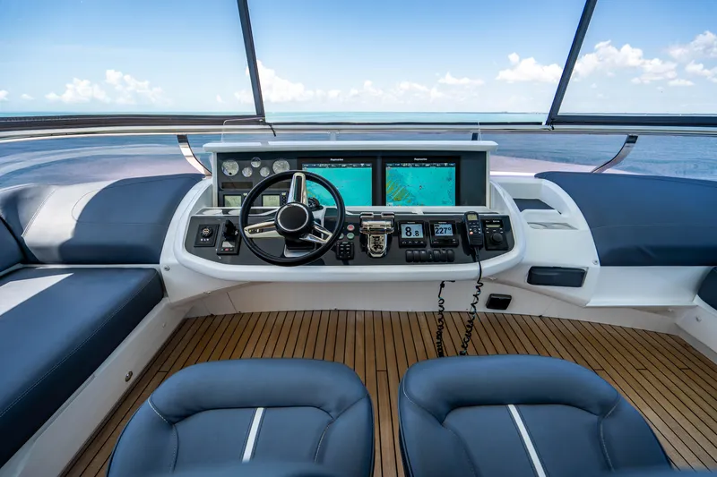 Slide: The Image of Helm station of 2018 Princess Y75 Motor Yacht with navigation screens and ocean view. - 47