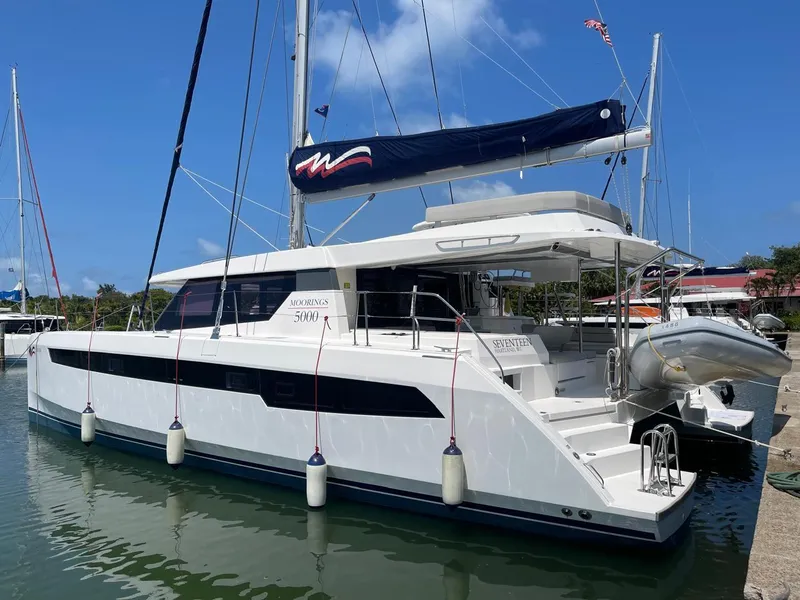Slide: The Image of 2020 Leopard 50 catamaran docked at marina with blue sky background. - 1
