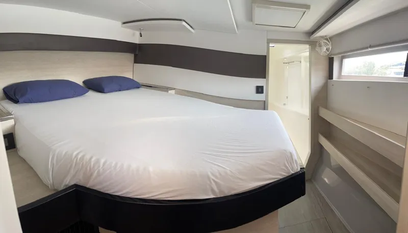 Slide: The Image of Modern bedroom interior in a 2020 Leopard 50 yacht with a large bed and natural light. - 13