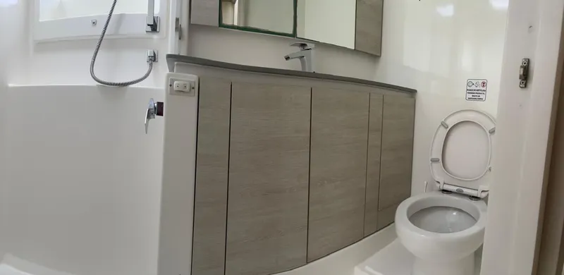 Slide: The Image of Modern bathroom in a 2020 Leopard 50 yacht with toilet, sink, and shower. - 15