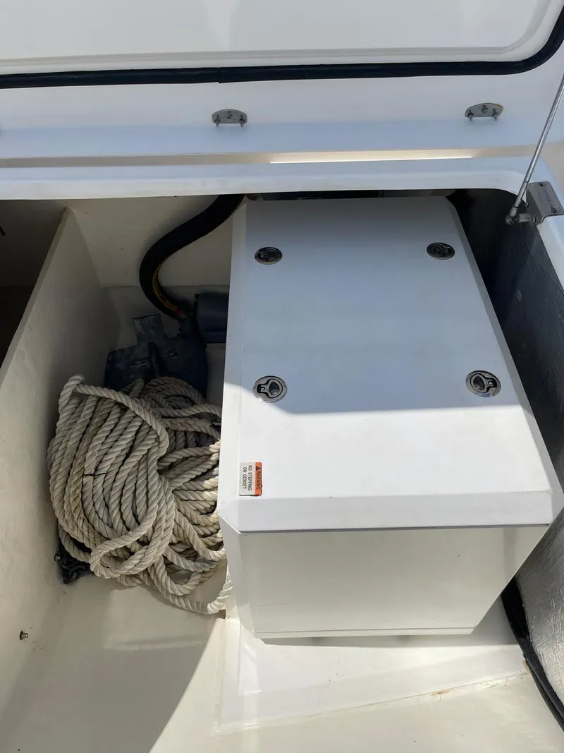 Slide: The Image of Storage compartment on a 2020 Leopard 50 boat with coiled rope. - 23