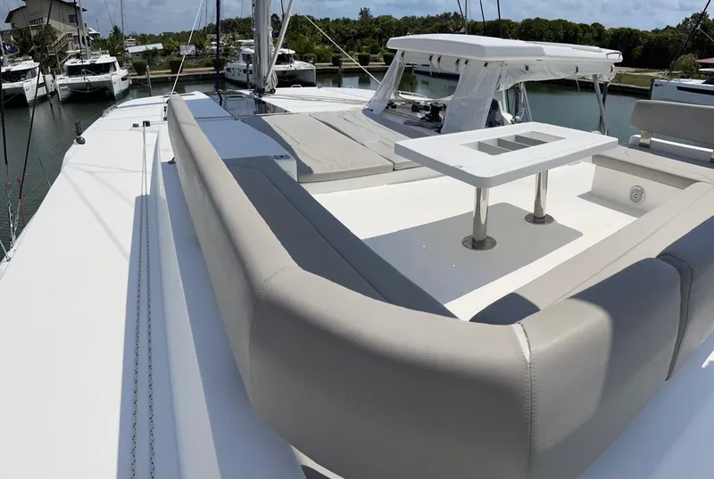 Slide: The Image of Leopard 50 yacht 2020 model, spacious deck with seating and table, docked at marina. - 28
