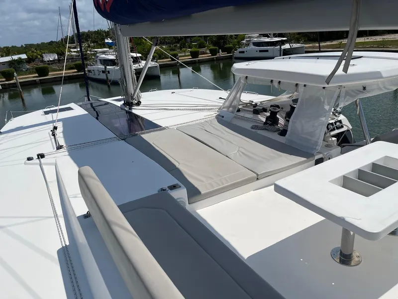 Slide: The Image of Leopard 50 catamaran 2020 model, spacious deck with seating and sunbathing area, docked at marina. - 31