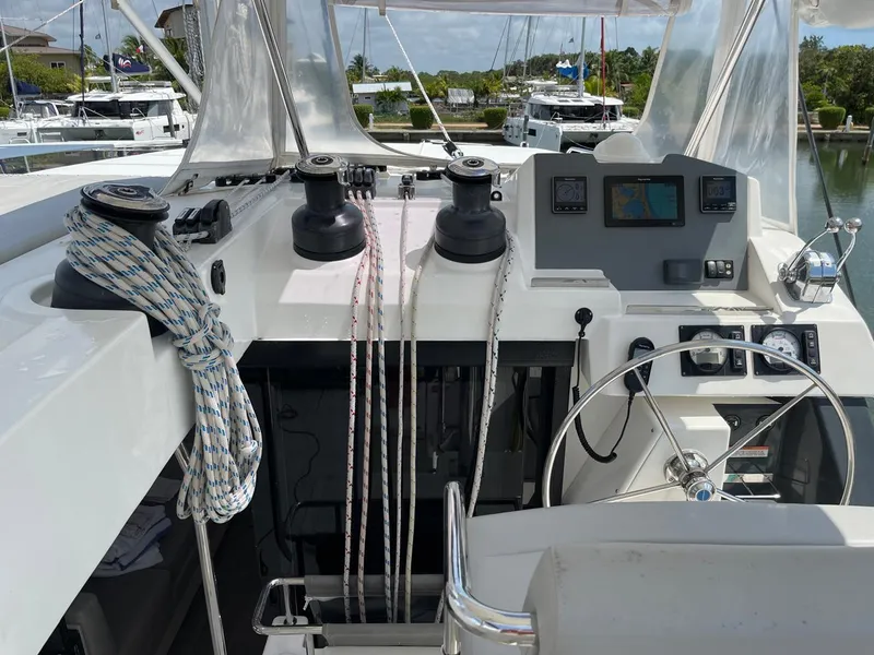Slide: The Image of Leopard 50 yacht cockpit with navigation equipment and ropes, docked in a marina, 2020 model. - 32