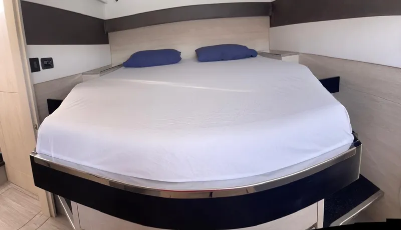 Slide: The Image of Leopard 50 yacht 2020 model bedroom with a neatly made bed and blue pillows. - 37