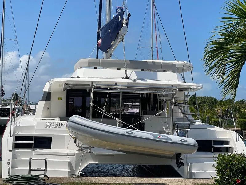 Slide: The Image of 2020 Leopard 50 catamaran with dinghy, docked at marina under clear blue sky. - 4