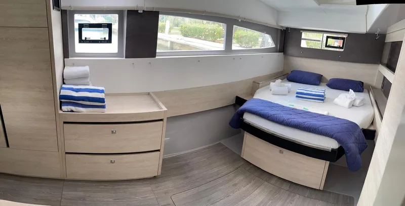 Slide: The Image of Modern bedroom interior of Leopard 50 yacht, 2020 model, with bed, drawers, and windows. - 41