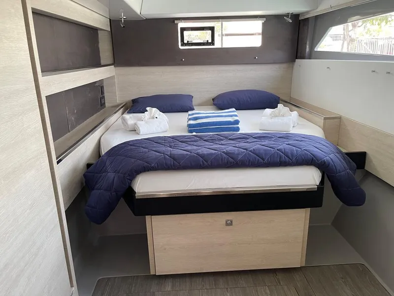 Slide: The Image of Leopard 50 yacht bedroom, 2020 model, with cozy bed and blue bedding. - 44