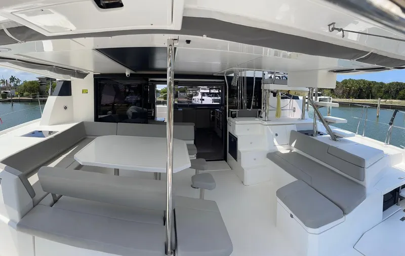 Slide: The Image of Spacious deck area of a 2020 Leopard 50 catamaran with seating and dining table. - 49
