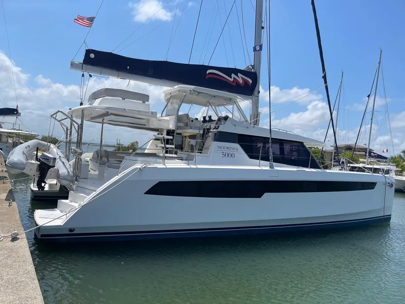 Slide: The Image of 2020 Leopard 50 catamaran docked at a marina on a sunny day. - 5