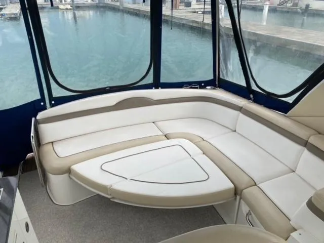 Slide: The Image of Sea Ray 370 Sundancer 2012 interior seating area with marina view. - 10