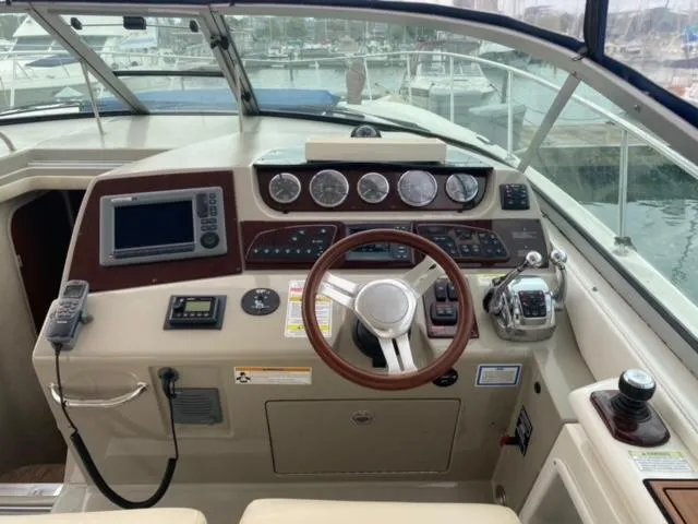 Slide: The Image of Sea Ray 370 Sundancer 2012 boat helm with navigation instruments and steering wheel. - 11