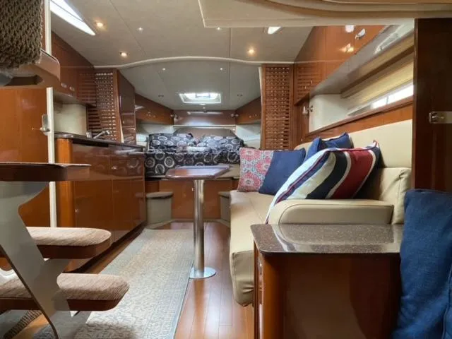Slide: The Image of Interior of 2012 Sea Ray 370 Sundancer yacht with modern furnishings and cozy seating. - 12