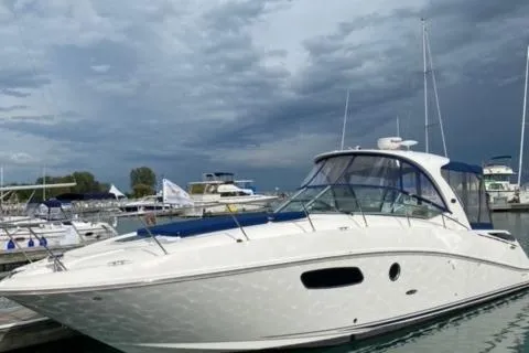 Slide: The Image of 2012 Sea Ray 370 Sundancer docked at a marina under cloudy skies. - 20