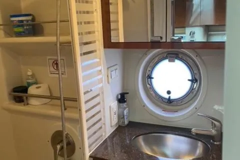 Slide: The Image of Sea Ray 370 Sundancer 2012 bathroom with sink, porthole, and shower. - 21