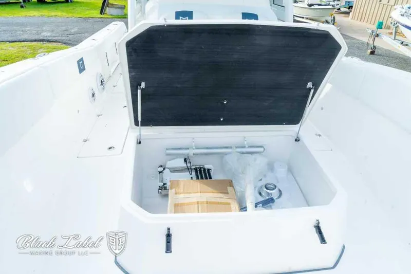 Slide: The Image of 2025 Sea Fox 328 Commander Center Console storage compartment open. - 12