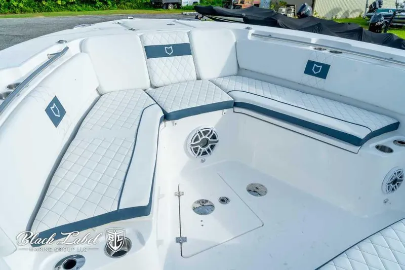 Slide: The Image of 2025 Sea Fox 328 Commander Center Console boat seating area with white and blue cushions. - 13