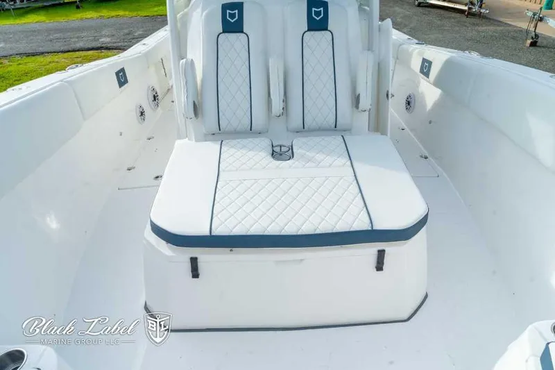 Slide: The Image of 2025 Sea Fox 328 Commander Center Console boat seating area with white and blue upholstery. - 14