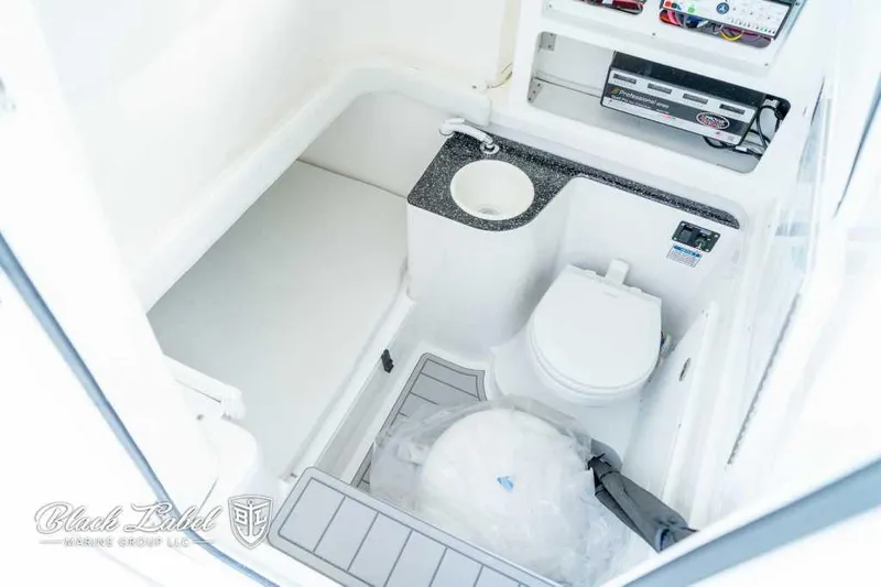 Slide: The Image of 2025 Sea Fox 328 Commander Center Console boat interior with toilet and sink. - 15