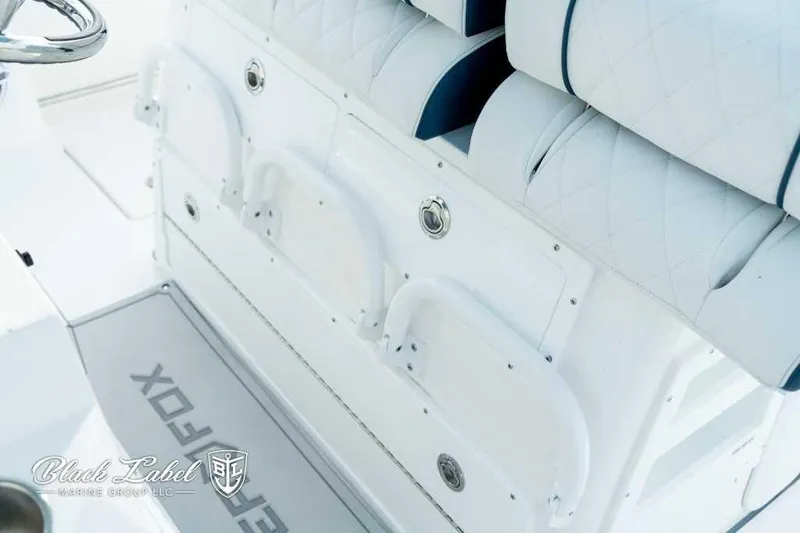 Slide: The Image of 2025 Sea Fox 328 Commander Center Console interior with white seating and storage compartments. - 18