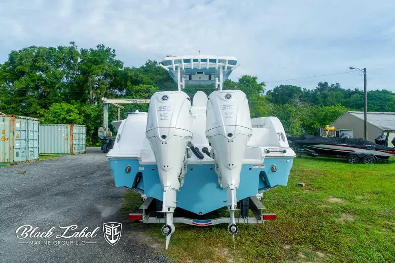Slide: The Image of 2025 Sea Fox 328 Commander Center Console with twin 350 engines, rear view. - 3