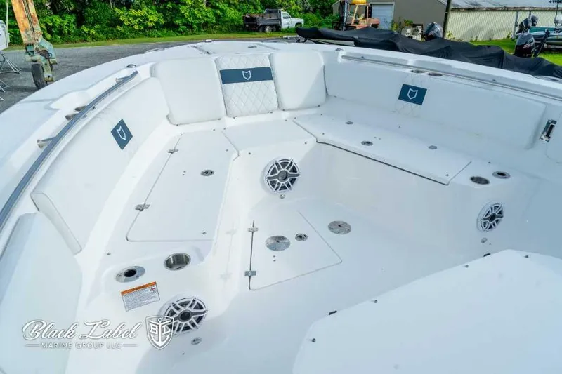 Slide: The Image of 2025 Sea Fox 328 Commander Center Console boat interior with seating and speakers. - 5