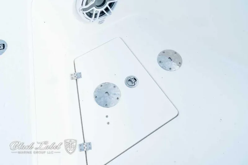 Slide: The Image of 2025 Sea Fox 328 Commander Center Console deck with storage hatch and speaker. - 9