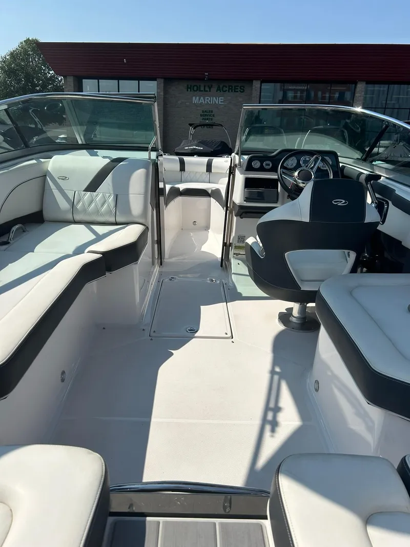 Slide: The Image of 2018 Regal 2300 Bowrider boat interior with white and black seating. - 10