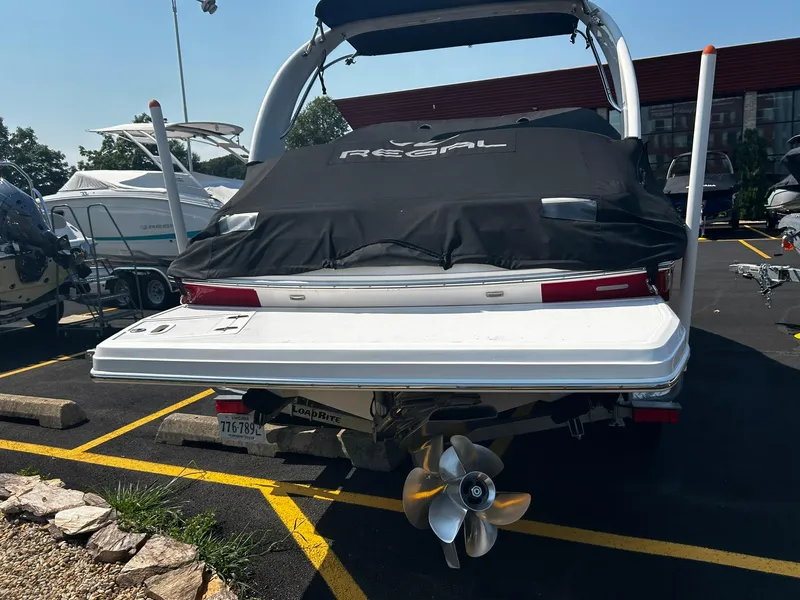Slide: The Image of 2018 Regal 2300 Bowrider boat, rear view with covered deck and propeller. - 2