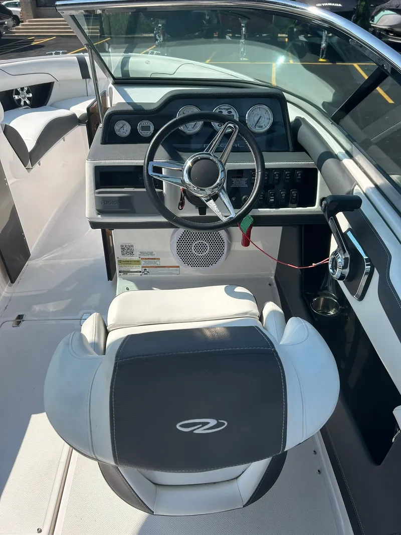 Slide: The Image of 2018 Regal 2300 Bowrider boat interior with steering wheel and dashboard. - 6