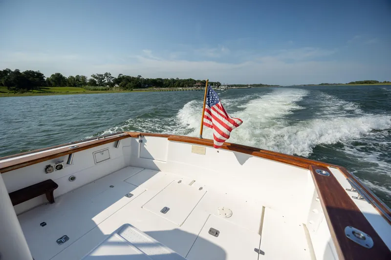 Slide: The Image of 1998 Little Harbor WhisperJet 36 boat cruising with American flag. - 11