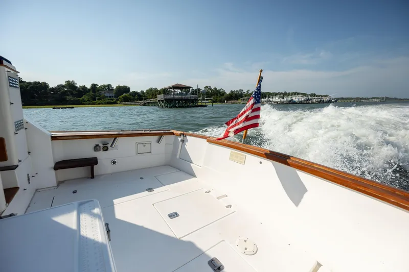 Slide: The Image of 1998 Little Harbor WhisperJet 36 cruising on a sunny day with American flag. - 12