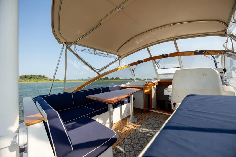 Slide: The Image of 1998 Little Harbor WhisperJet 36 boat interior with blue seating and wooden table. - 16