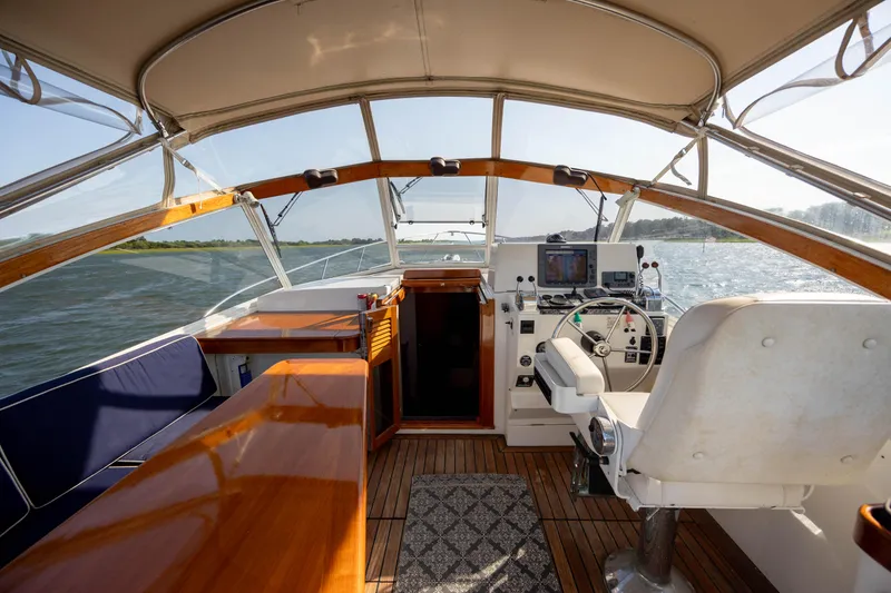 Slide: The Image of Interior of a 1998 Little Harbor WhisperJet 36 boat with helm and seating area. - 17