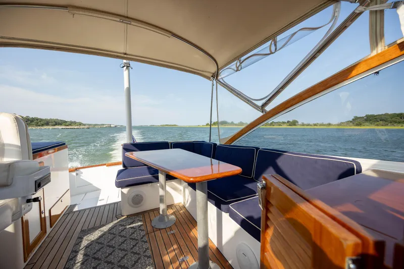 Slide: The Image of 1998 Little Harbor WhisperJet 36 boat interior with blue seating and wooden table. - 18