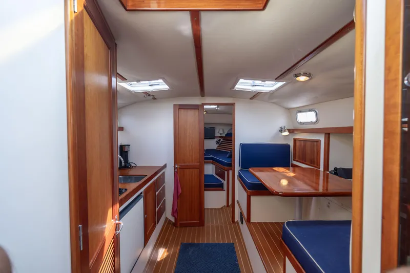 Slide: The Image of 1998 Little Harbor WhisperJet 36 interior with wood finishes and blue seating. - 21