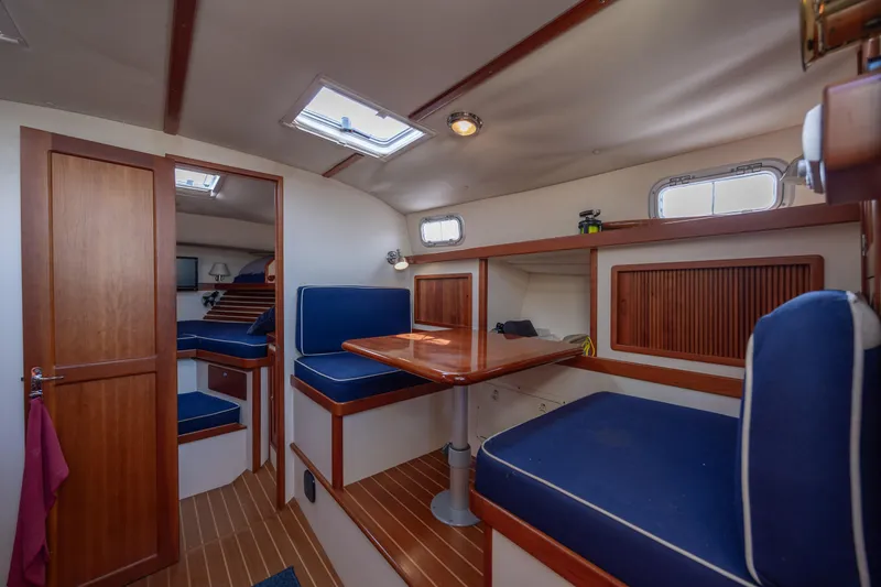 Slide: The Image of 1998 Little Harbor WhisperJet 36 interior with blue seating and wooden accents. - 22