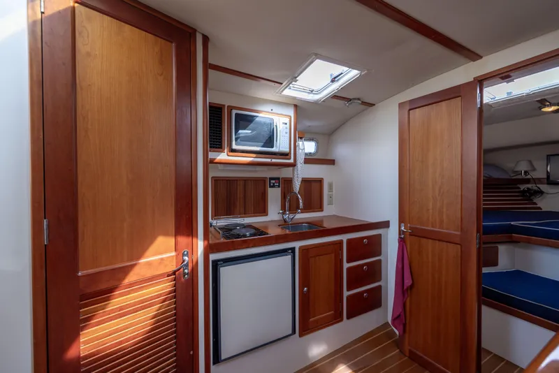 Slide: The Image of 1998 Little Harbor WhisperJet 36 interior kitchen with wood cabinetry and modern appliances. - 23