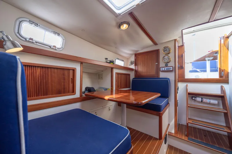 Slide: The Image of 1998 Little Harbor WhisperJet 36 interior with blue seating and wooden table. - 26
