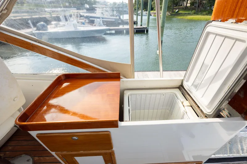 Slide: The Image of 1998 Little Harbor WhisperJet 36 boat interior with open cooler and wooden counter. - 46