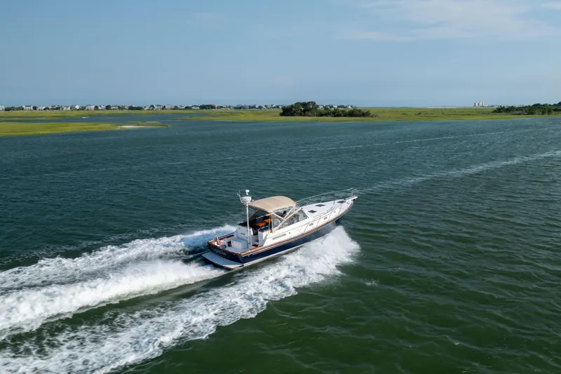 Slide: The Image of 1998 Little Harbor WhisperJet 36 cruising on open water. - 9