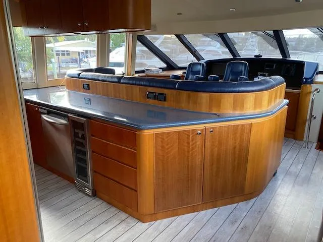 Slide: The Image of Luxurious 2003 West Bay 68 yacht interior with sleek wood cabinetry and modern seating. - 11