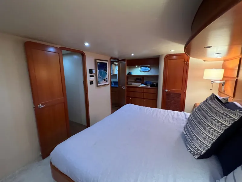 Slide: The Image of Luxurious bedroom interior of 2003 West Bay 68 yacht with wooden accents and cozy bedding. - 14