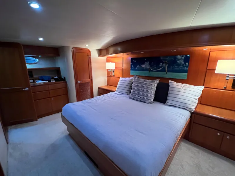 Slide: The Image of Luxurious bedroom interior of 2003 West Bay 68 yacht with cozy bed and wooden furnishings. - 15